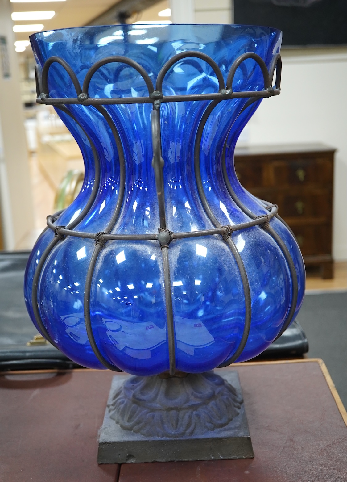 A wrought and cast iron mounted large blue glass vase, 49cm. Condition - would benefit from a clean, otherwise good